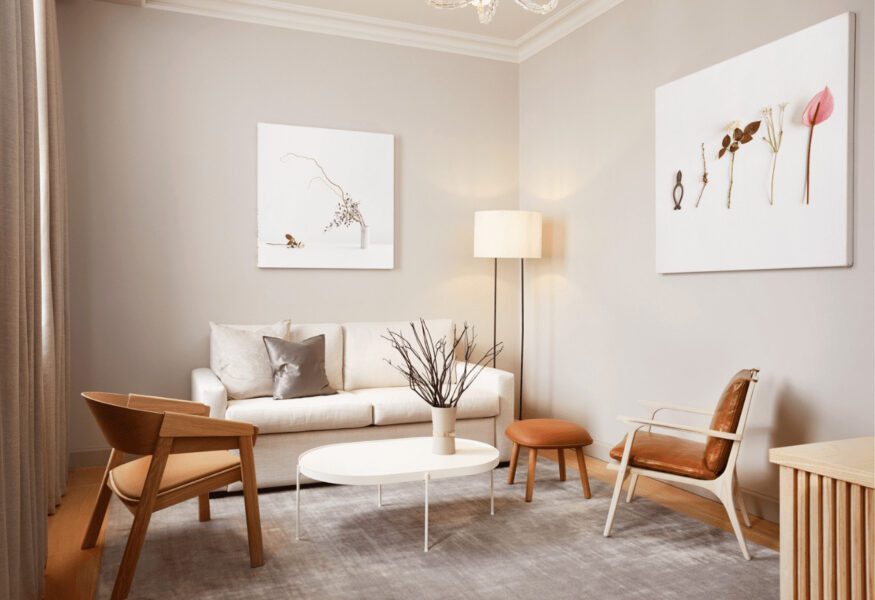 A modern living room with a light gray rug, wooden furniture, and a sense of tranquility.